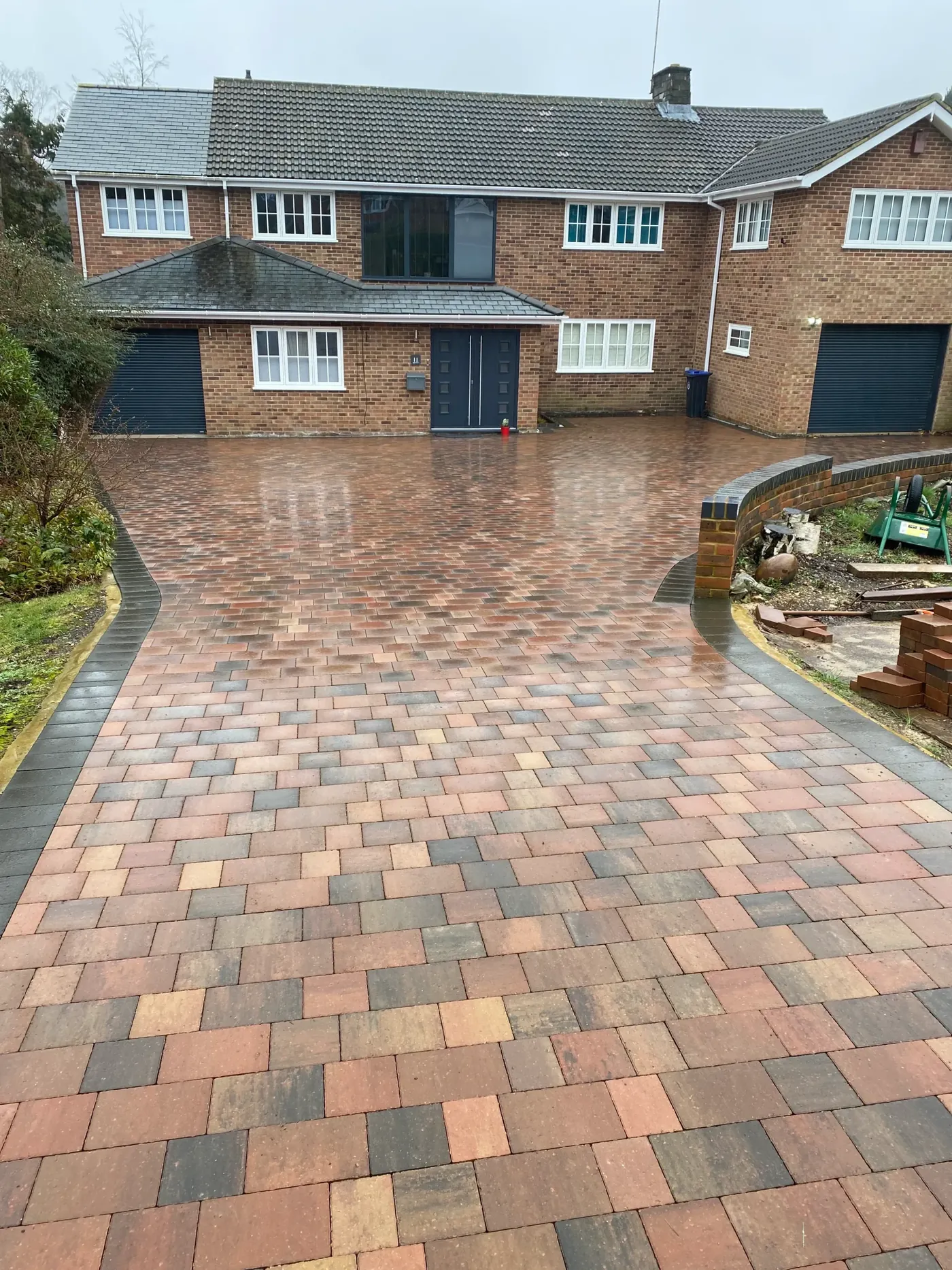 Block paved driveway in mixed grey and buff blocks running up to a semi-detached house