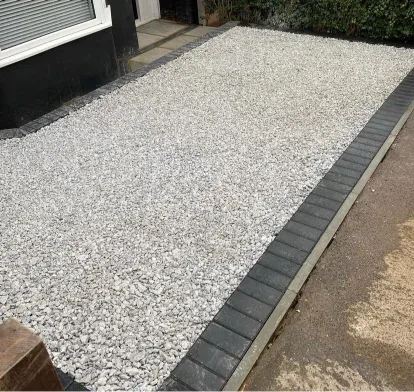 Gravel surface finished against a block paved apron