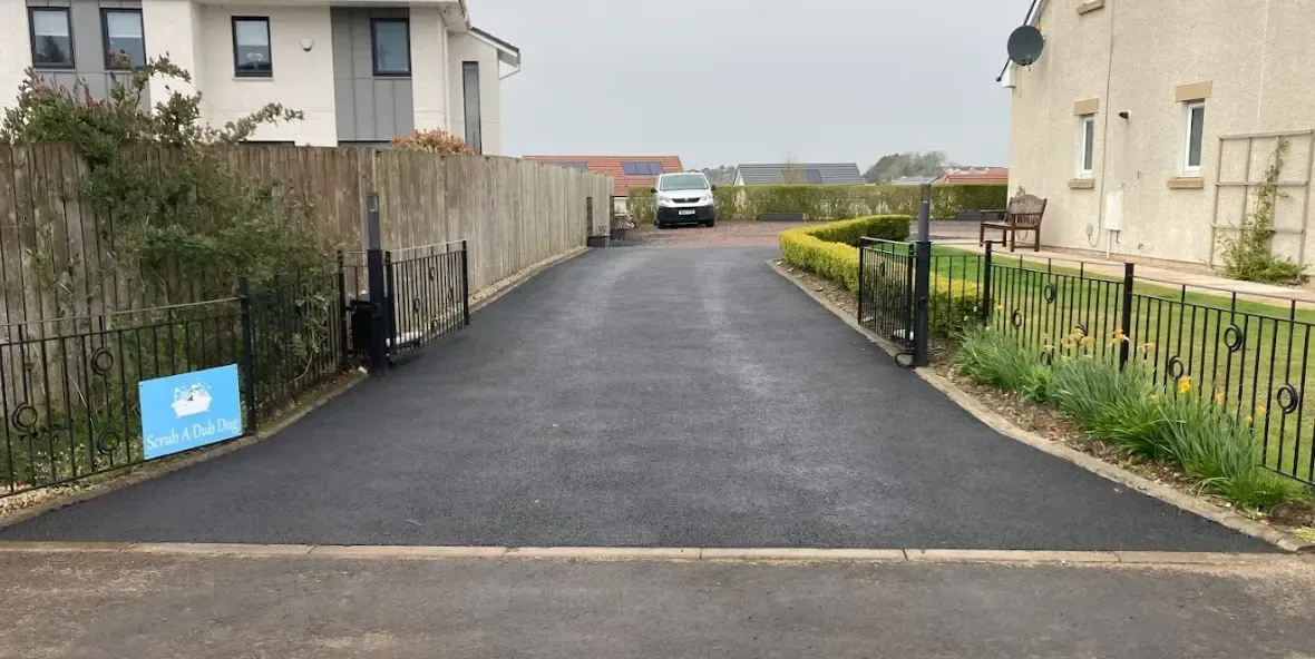 Long tarmac access drive laid in two courses